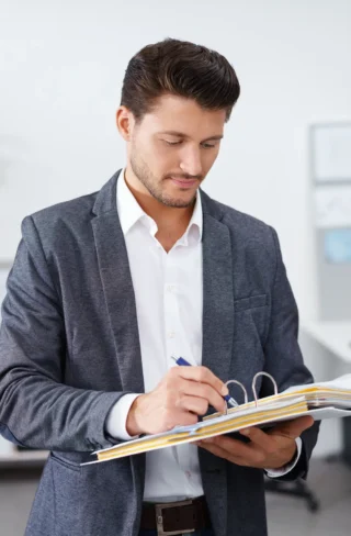 a man in a suit holding a folder