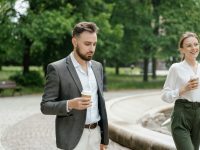 a man in a suit holding a coffee cup