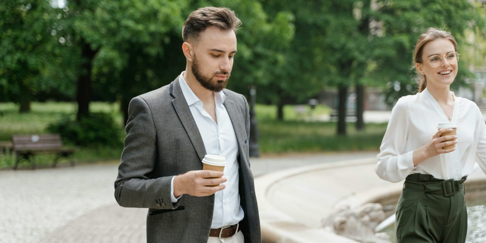 a man in a suit holding a coffee cup
