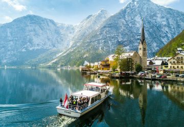 a boat on the water with mountains in the background